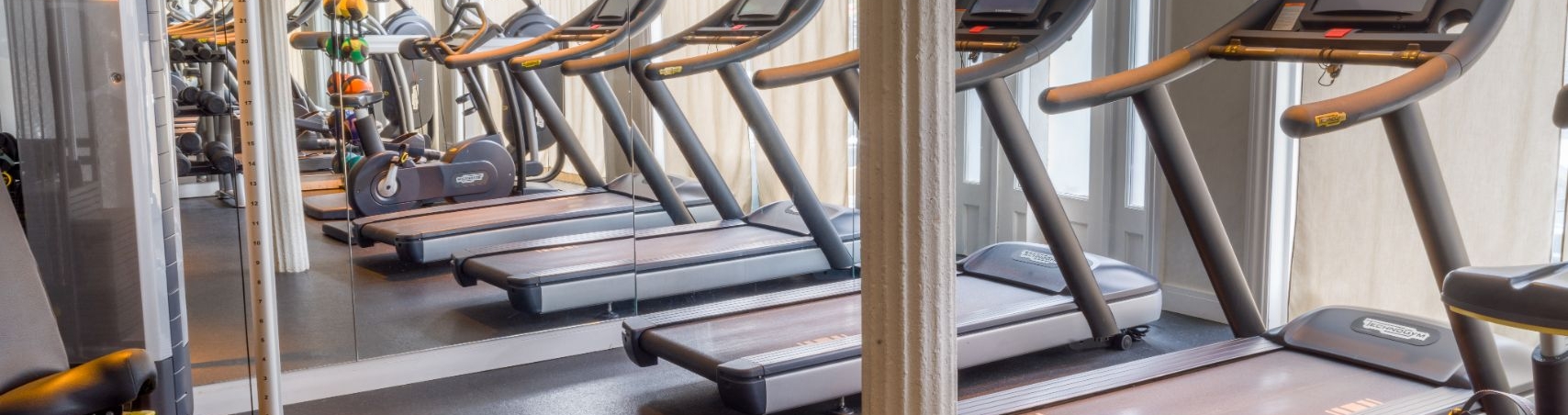 gym with treadmills and lifting equipment
